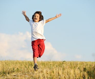Happy child running on beautiful field